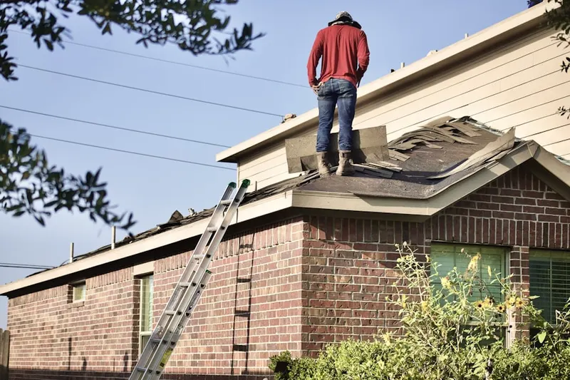 Professional roofer working on a residential roof in Oreland